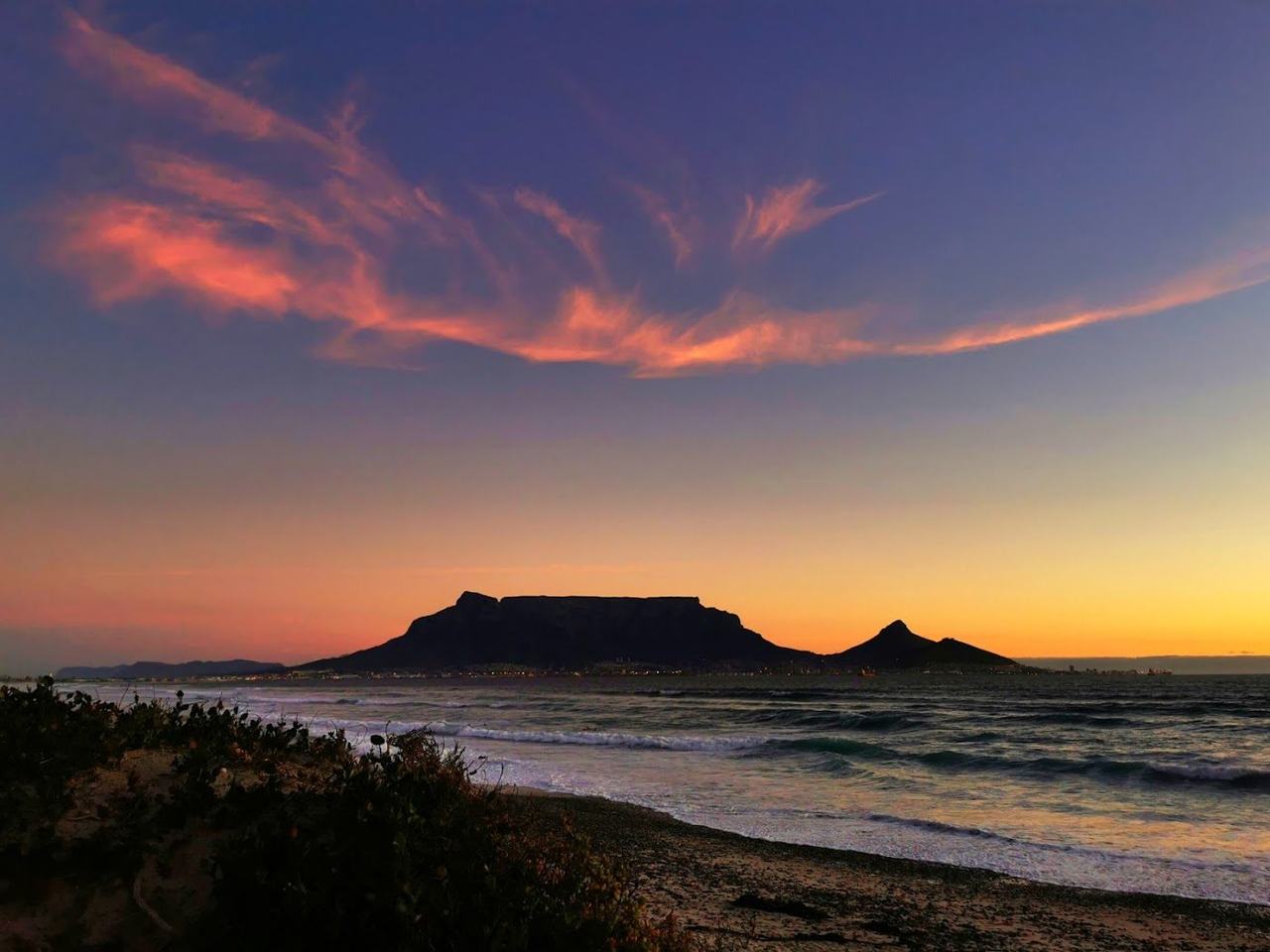Milnerton Beach with Table Mountain across Table Bay and the lighthouse in Cape Town