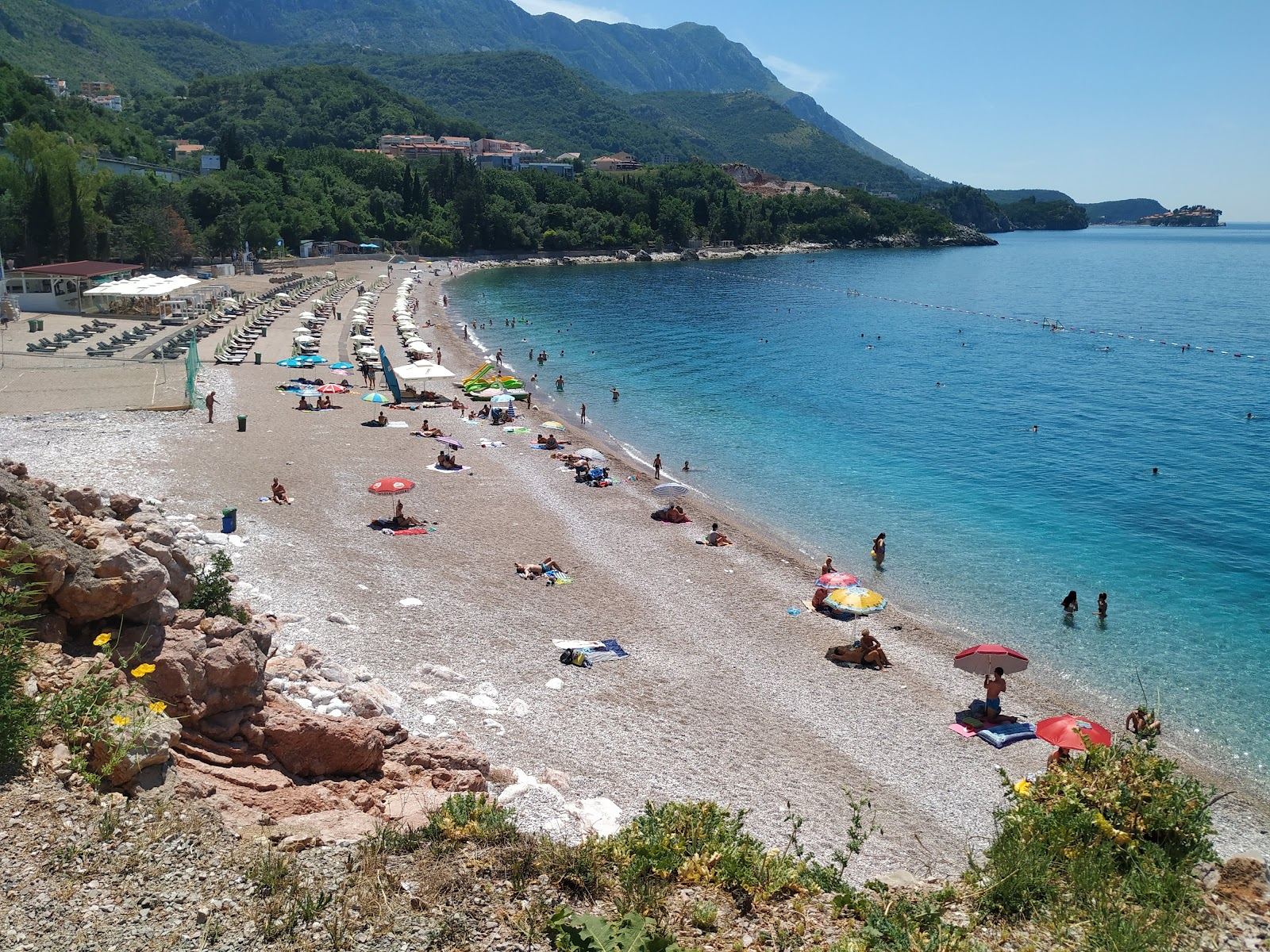 Clear turquoise water over white pebbles at Kamenovo bay on the Budva Riviera in Montenegro