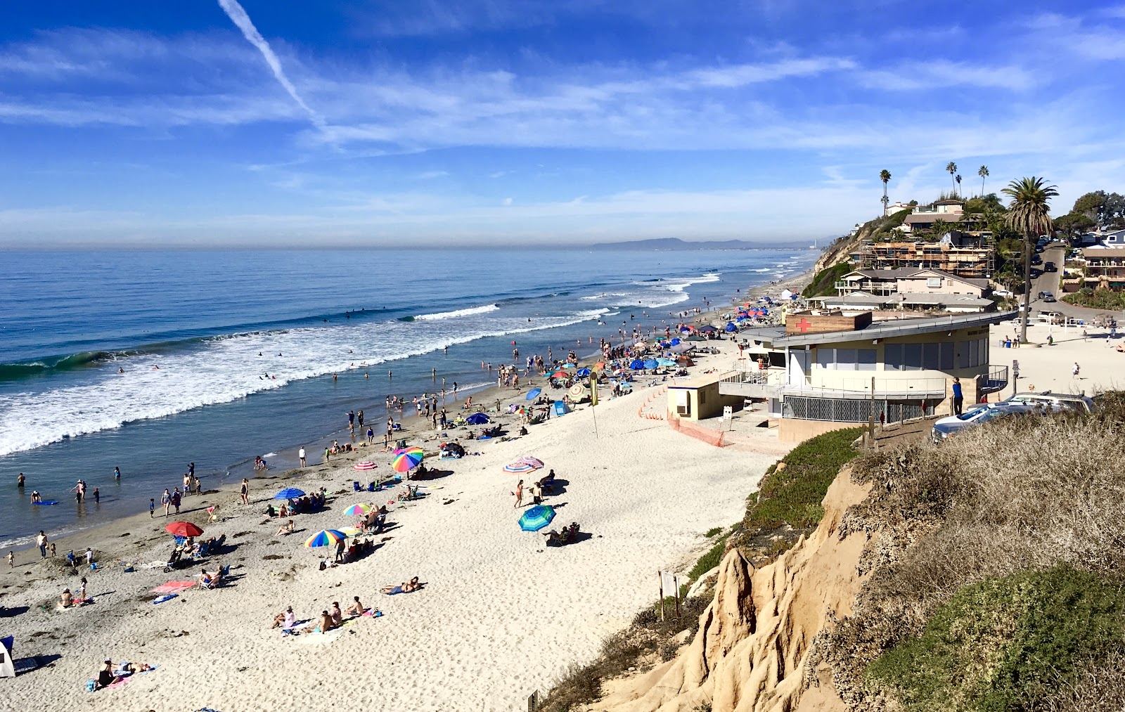 Moonlight Beach Encinitas wide sand with bluffs behind and gentle surf near San Diego