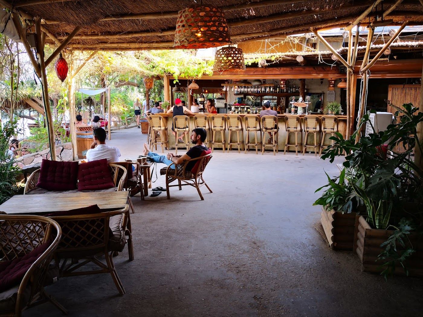Shaded loungers and the relaxed kitchen at Mosh Beach in Eilat
