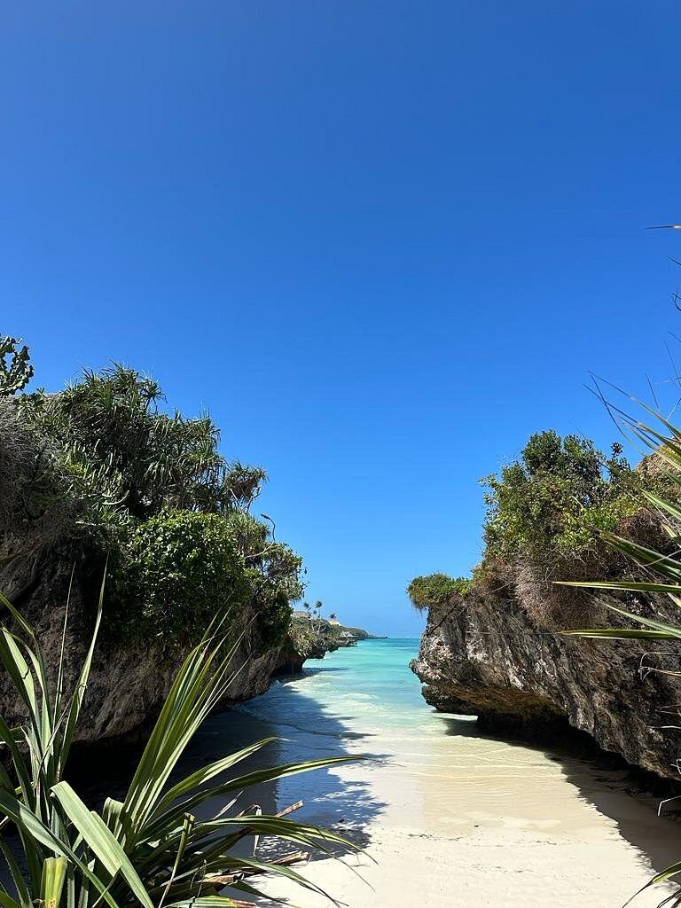 Cliffs and clear water above the secluded cove at Mtende beach in southern Zanzibar