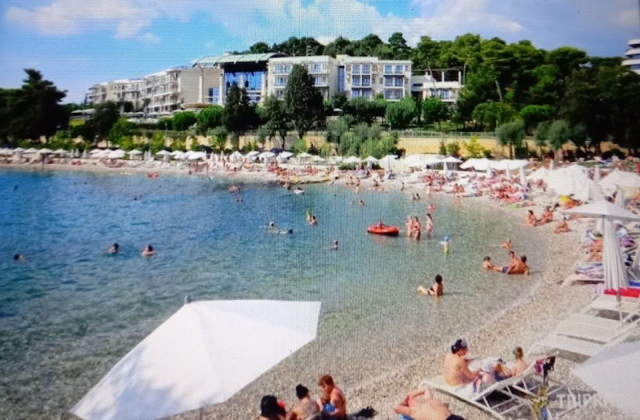 Clear water and pebble shore at Mulini beach near Rovinj old town in Istria