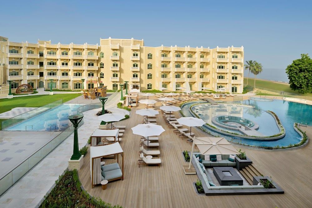 Gardens and seafront beach at a hotel on the Shatti Al Qurum shore in Muscat