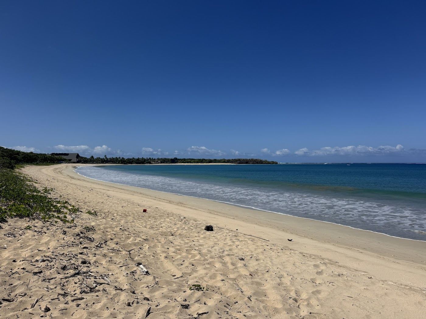 White sand curving along the gentle bay at Natadola Beach in Fiji
