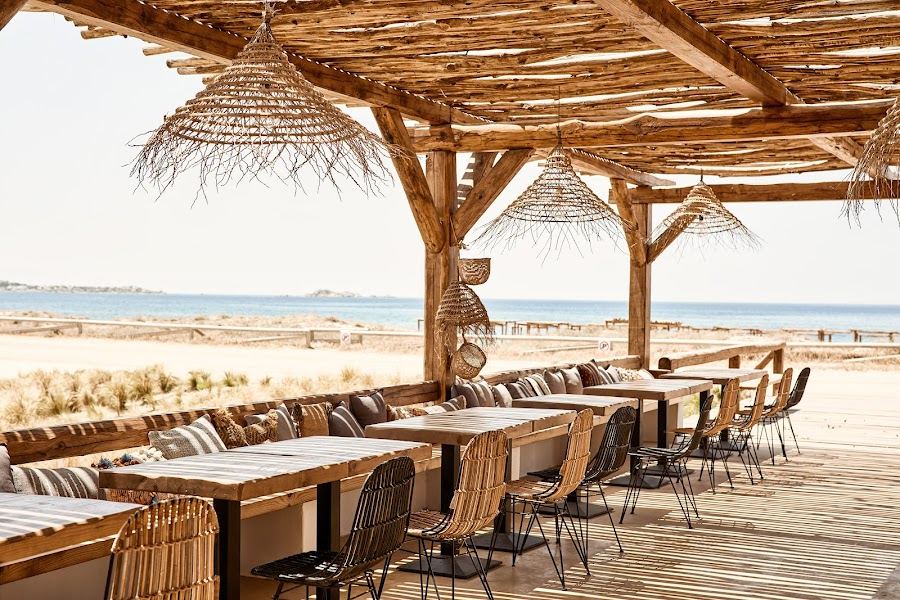Beach bar and restaurant tables beside the sea at Tortuga on Plaka beach in Naxos