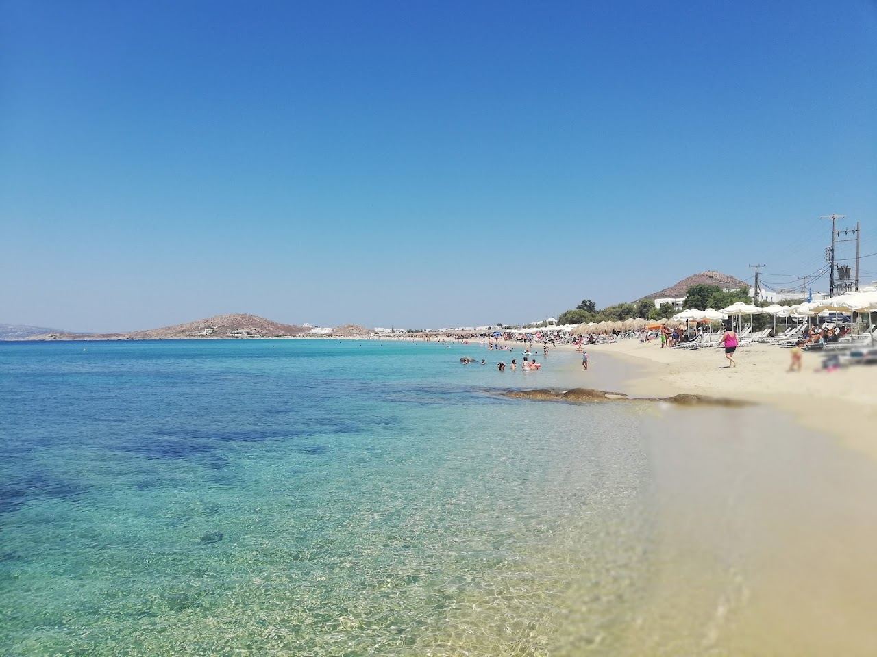 Long golden sand and shallow blue water on the west coast of Naxos