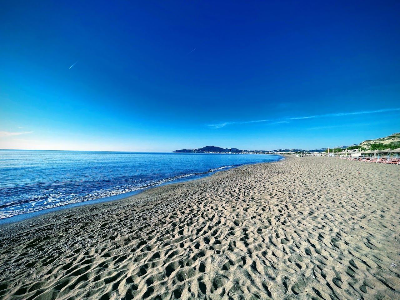 Long sandy beach and calm sea at Faliraki on the east coast of Rhodes