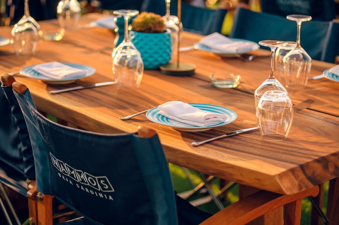 A glamorous beach club with loungers and clear water on the Costa Smeralda in Sardinia