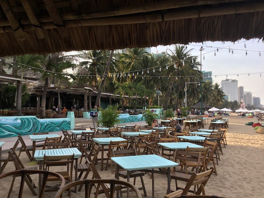 Beachfront daybeds and dining at the Sailing Club on Nha Trang beach