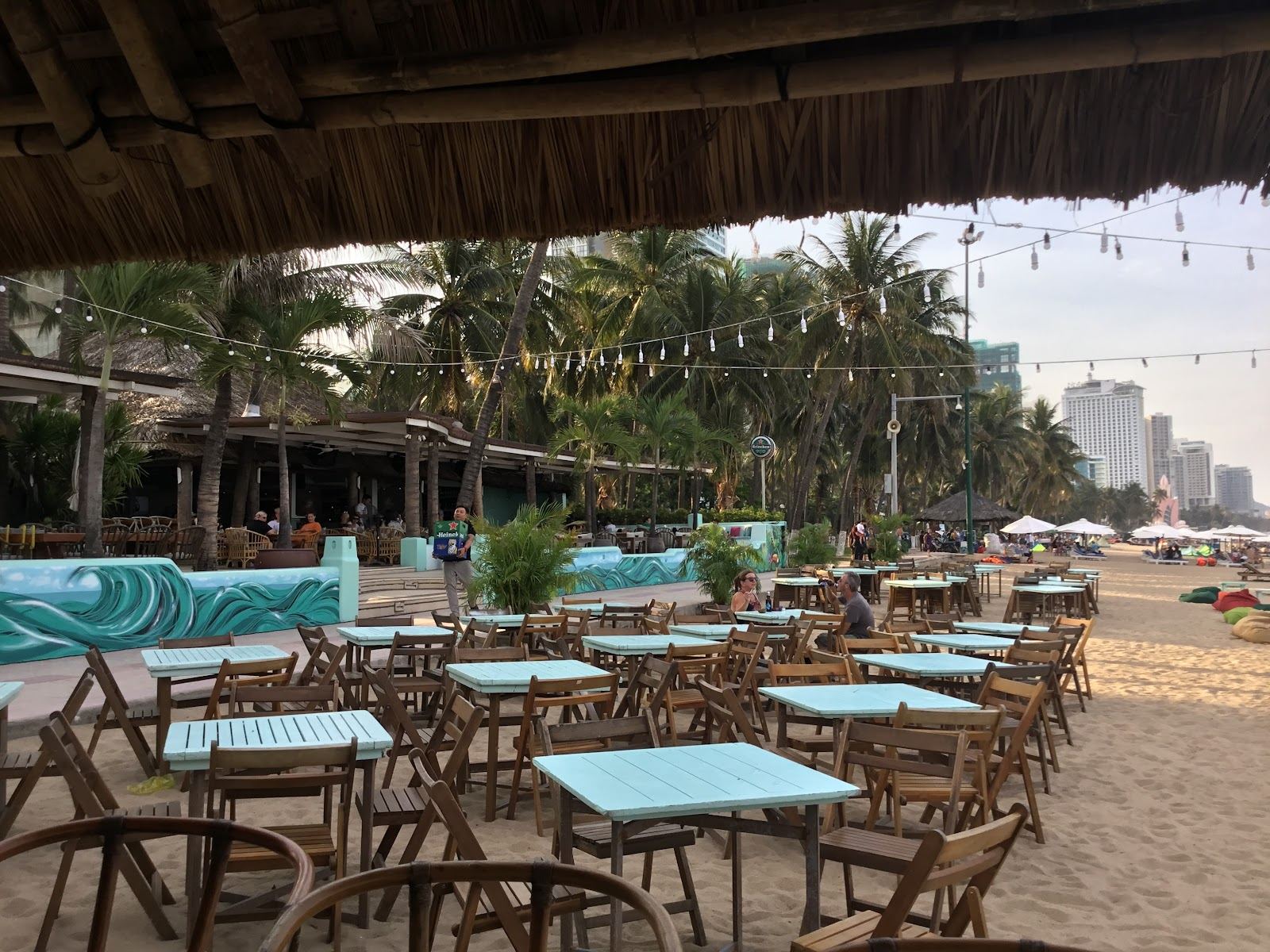 Beachfront daybeds and palms at the Sailing Club on Nha Trang beach in Vietnam