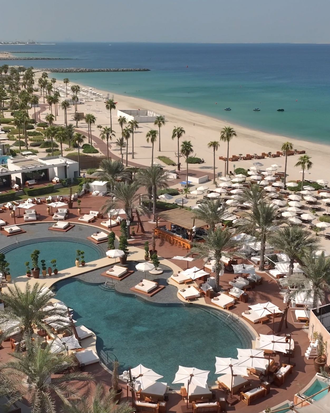 Daybeds and pool at Nikki Beach Dubai on Pearl Jumeirah facing the Arabian Gulf