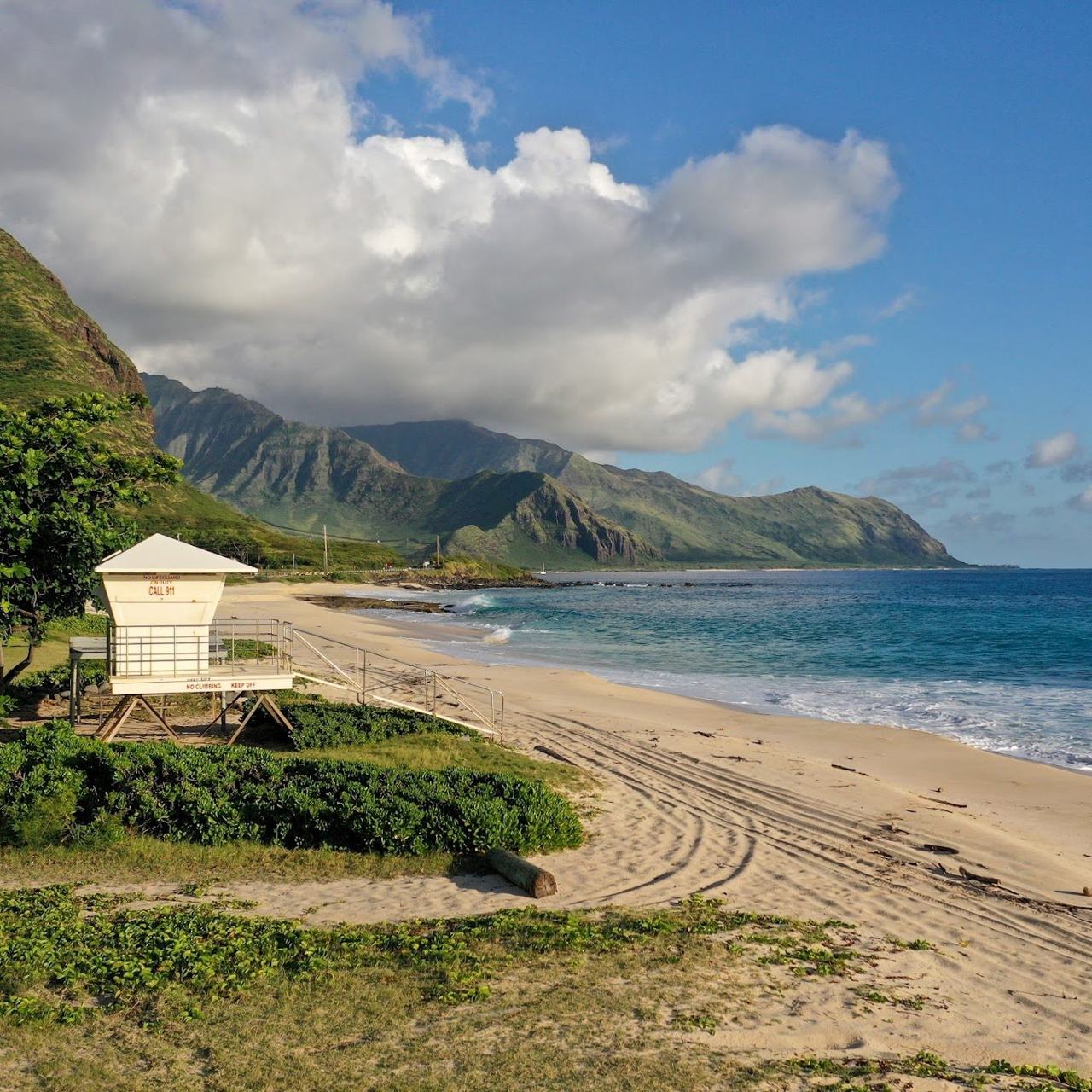 Empty golden sand and open ocean at Yokohama Bay at the wild western end of Oahu Hawaii