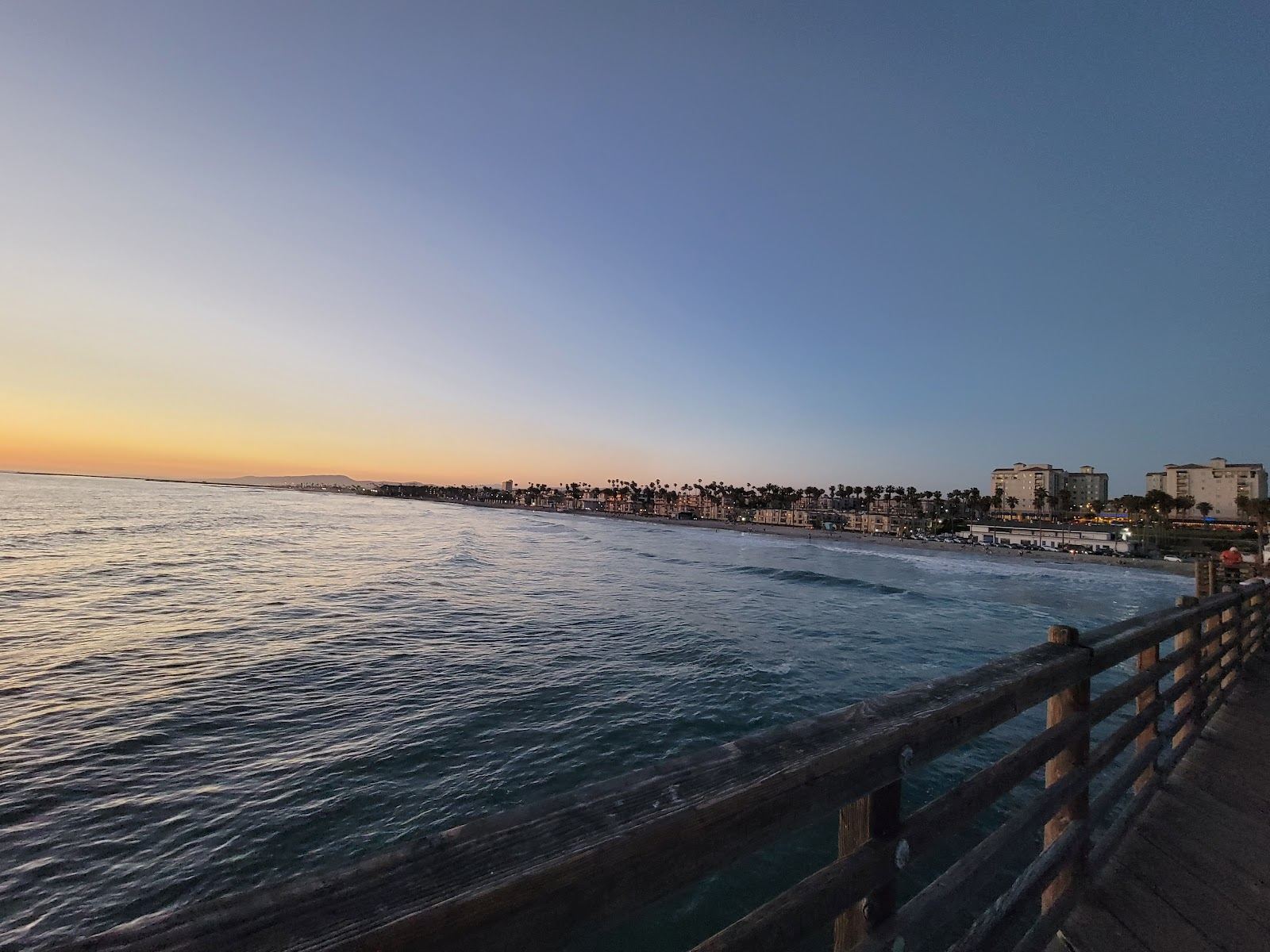 Ocean Beach San Diego wide free sand with surf and the village behind