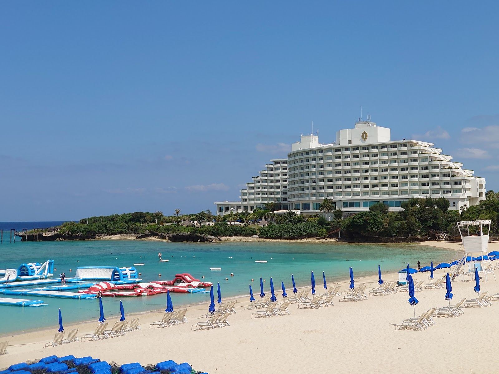 Clear reef water and headland at a watersports beach in Onna, Okinawa