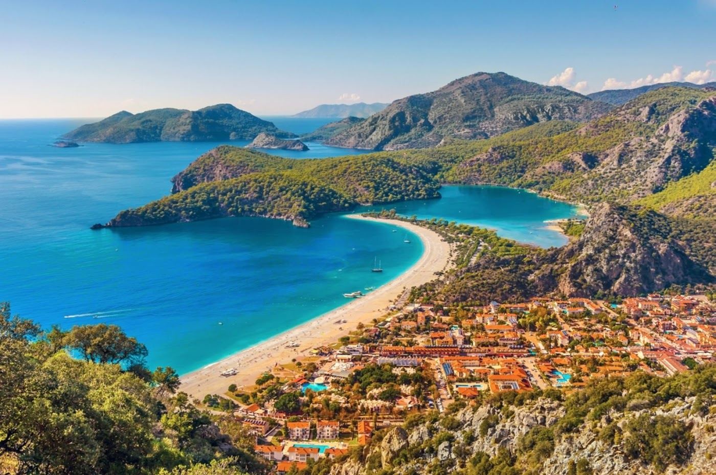 The calm turquoise Blue Lagoon at Oludeniz behind a sand spit near Fethiye in Turkey