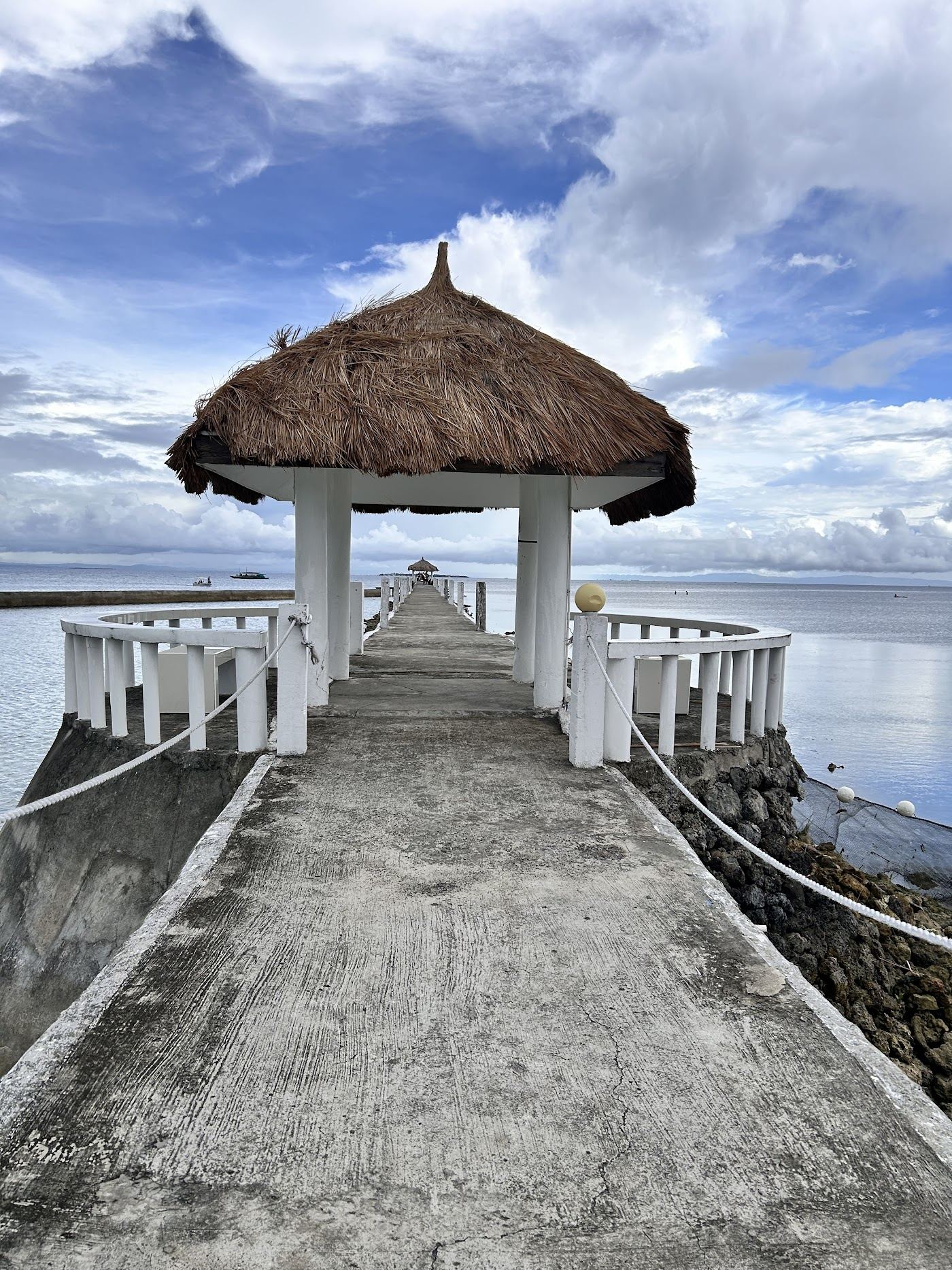 Long calm beach front and dive pier at Pacific Cebu Resort on the east shore of Mactan Island in Cebu Philippines