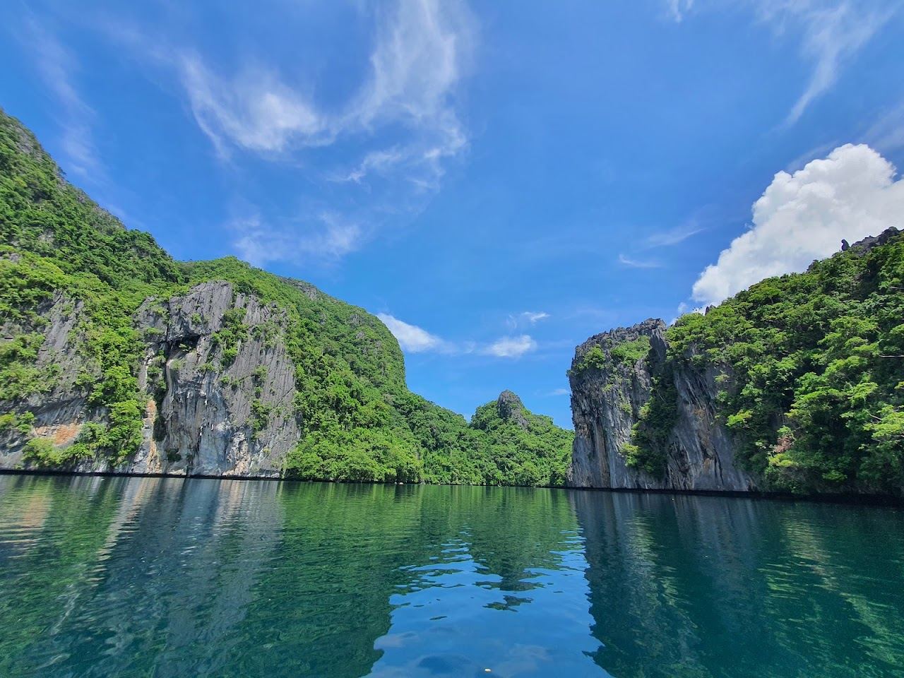 Kayakers entering the Big Lagoon framed by limestone cliffs near El Nido in Palawan