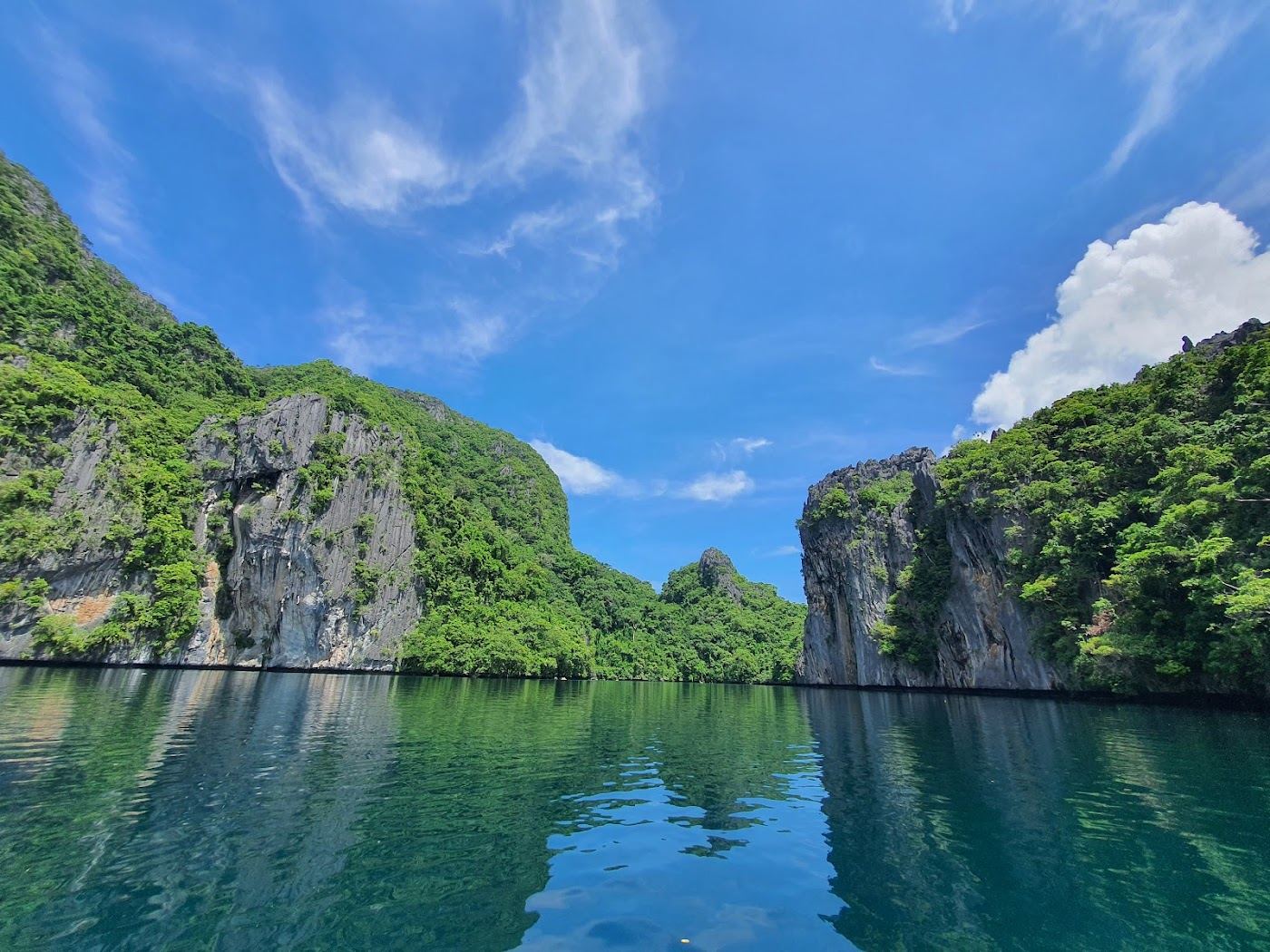Calm clear water and limestone islands on a bright dry season day in Palawan