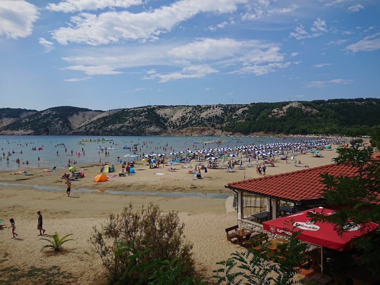 Paradise Beach Rajska plaza at Lopar on Rab island with a long curve of golden sand and shallow turquoise water on the Dalmatian Coast