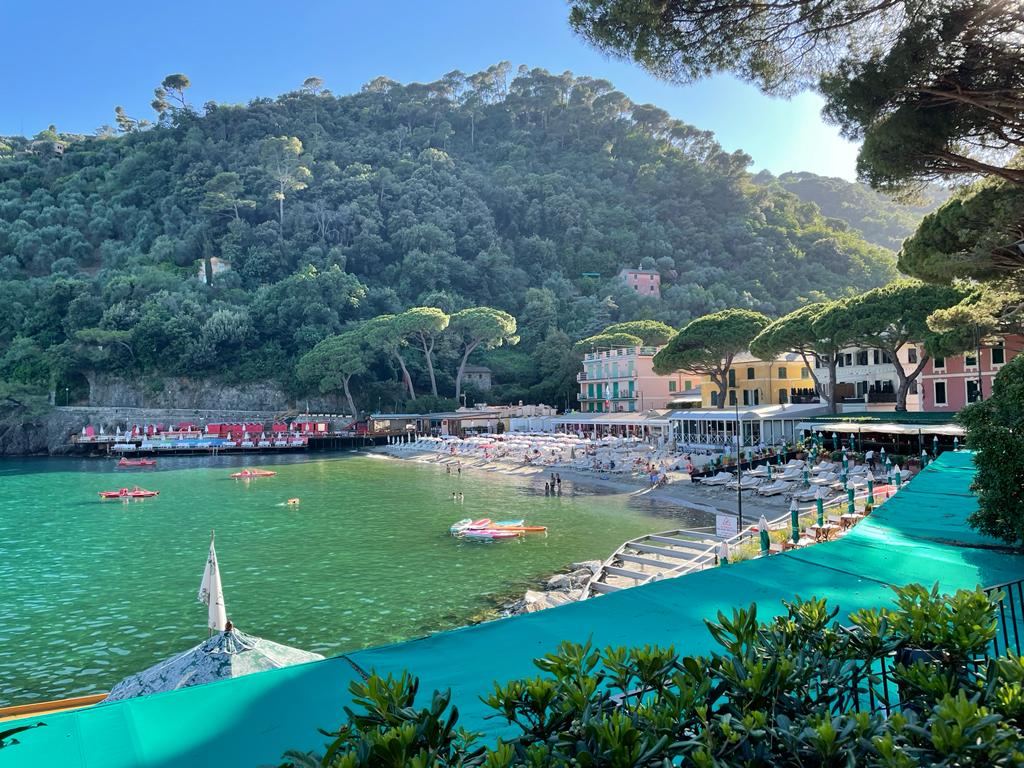 The emerald sheltered water of Paraggi bay below the green Portofino hills in Liguria