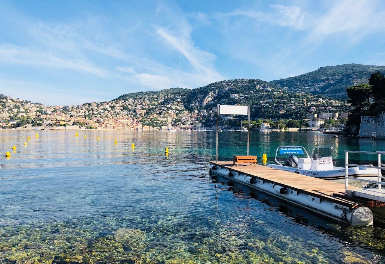 Calm beach and loungers at Plage de Passable on Saint Jean Cap Ferrat facing Villefranche bay