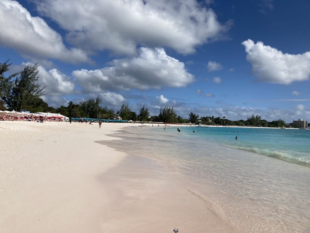 Calm clear water and pale sand curving along Pebbles Beach on Carlisle Bay near Bridgetown Barbados