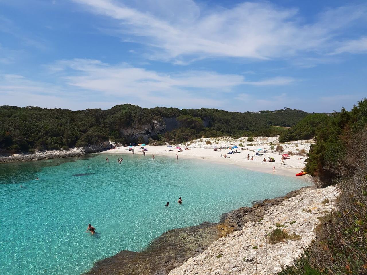 Small sheltered cove of Petit Sperone near Bonifacio with clear turquoise water