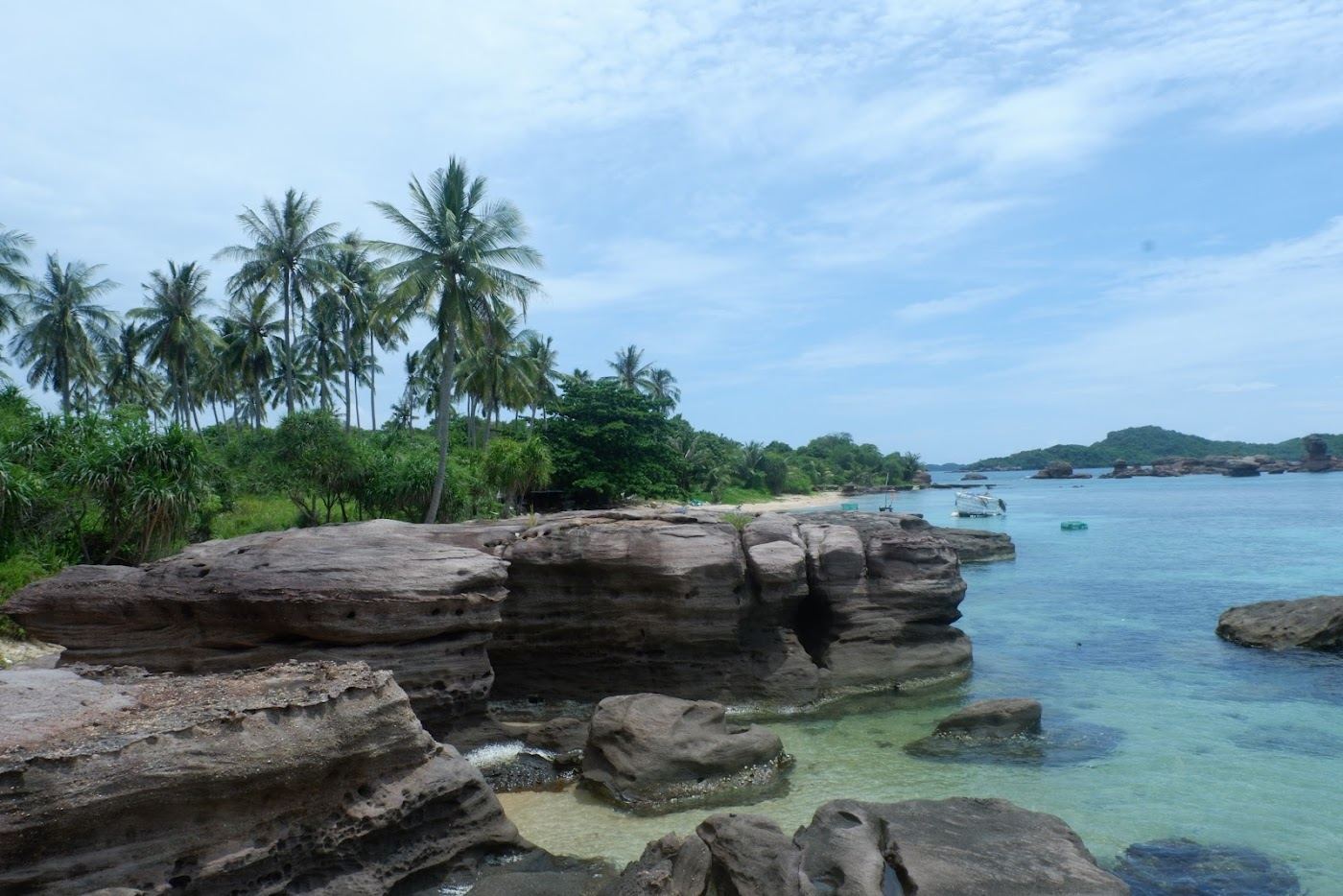 Clear turquoise water around a small forested island in the An Thoi archipelago, Phu Quoc, Vietnam