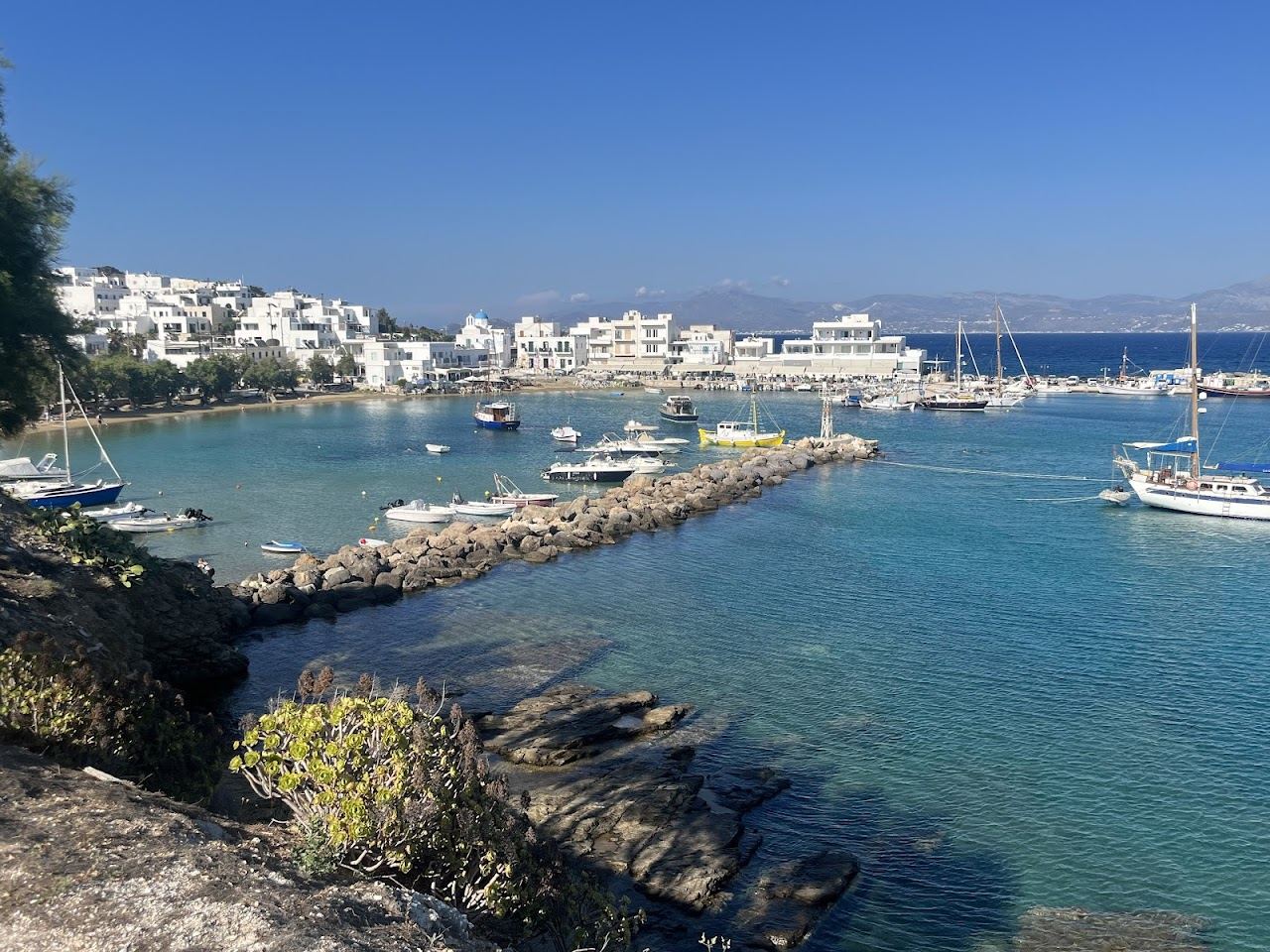 The sheltered harbour and small sandy beach of Piso Livadi village on the east coast of Paros