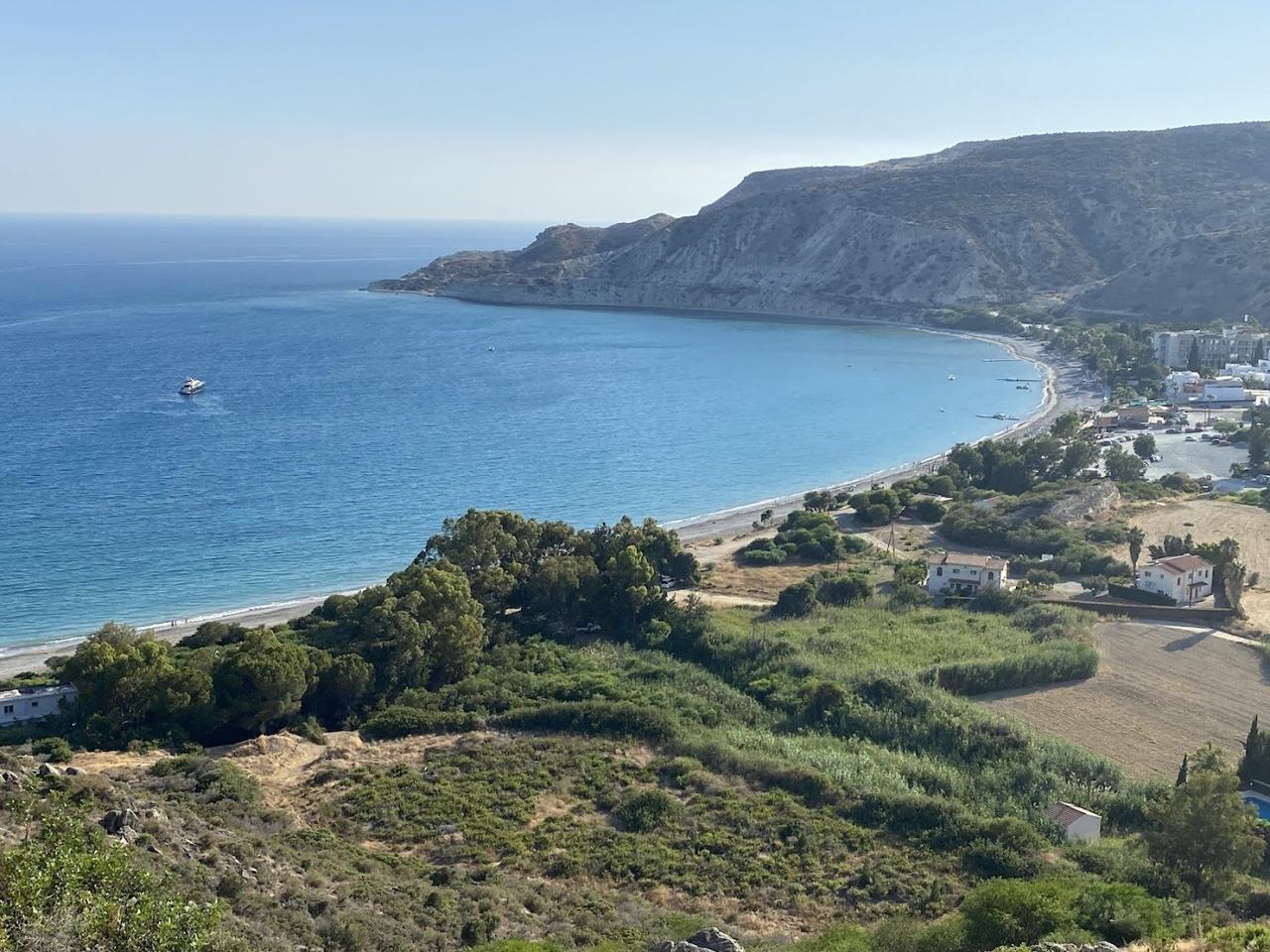 Wide curve of sand and pebble below white cliffs at Pissouri Bay between Limassol and Paphos in Cyprus