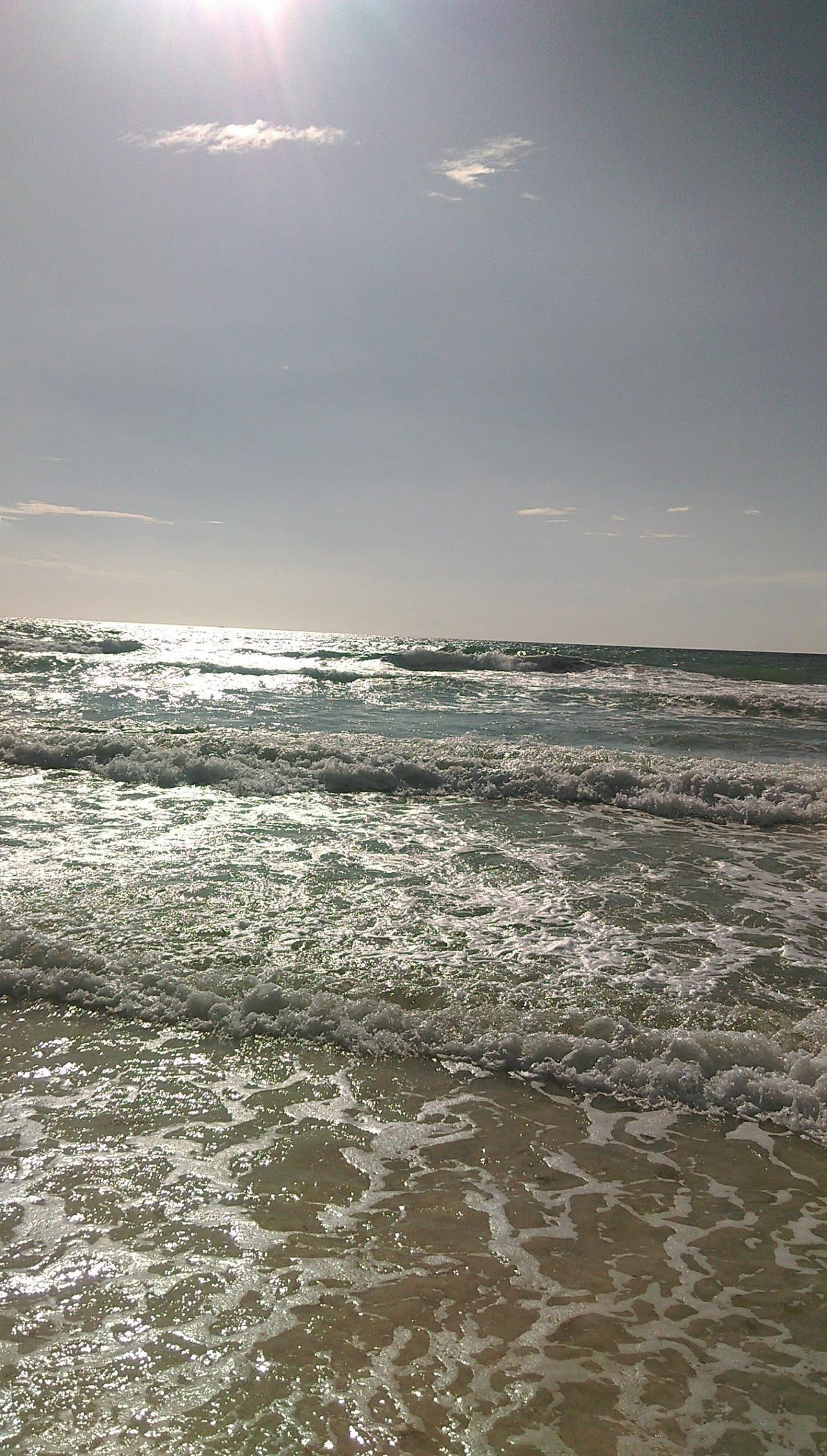 Open Caribbean surf along the broad sand of Playa Ballenas between the resorts