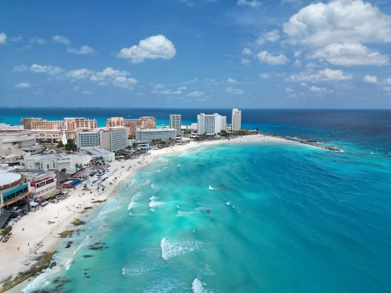 Lively surf and beachgoers at Playa Chac Mool in the Cancun hotel zone