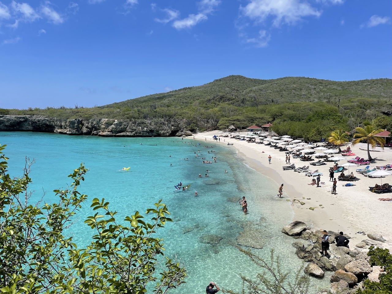 The clear water and low cliffs framing the small Kleine Knip cove in Curacao