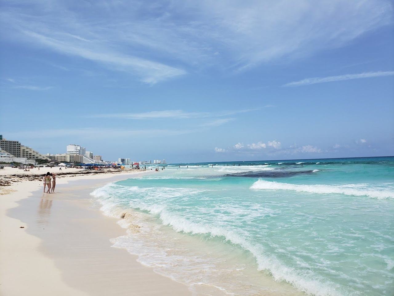 Wide open white sand and turquoise Caribbean surf at Playa Marlin in the Cancun hotel zone