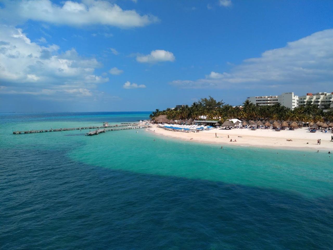 Shallow clear water and palms at Playa Norte on Isla Mujeres near sunset
