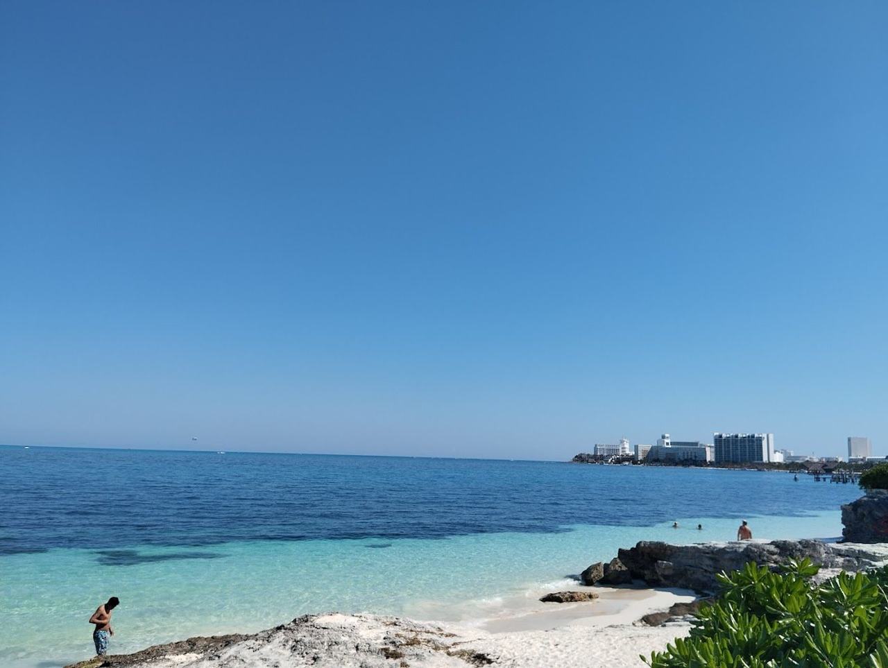 Boats and swimmers in the sheltered water at Playa Tortugas in the Cancun hotel zone
