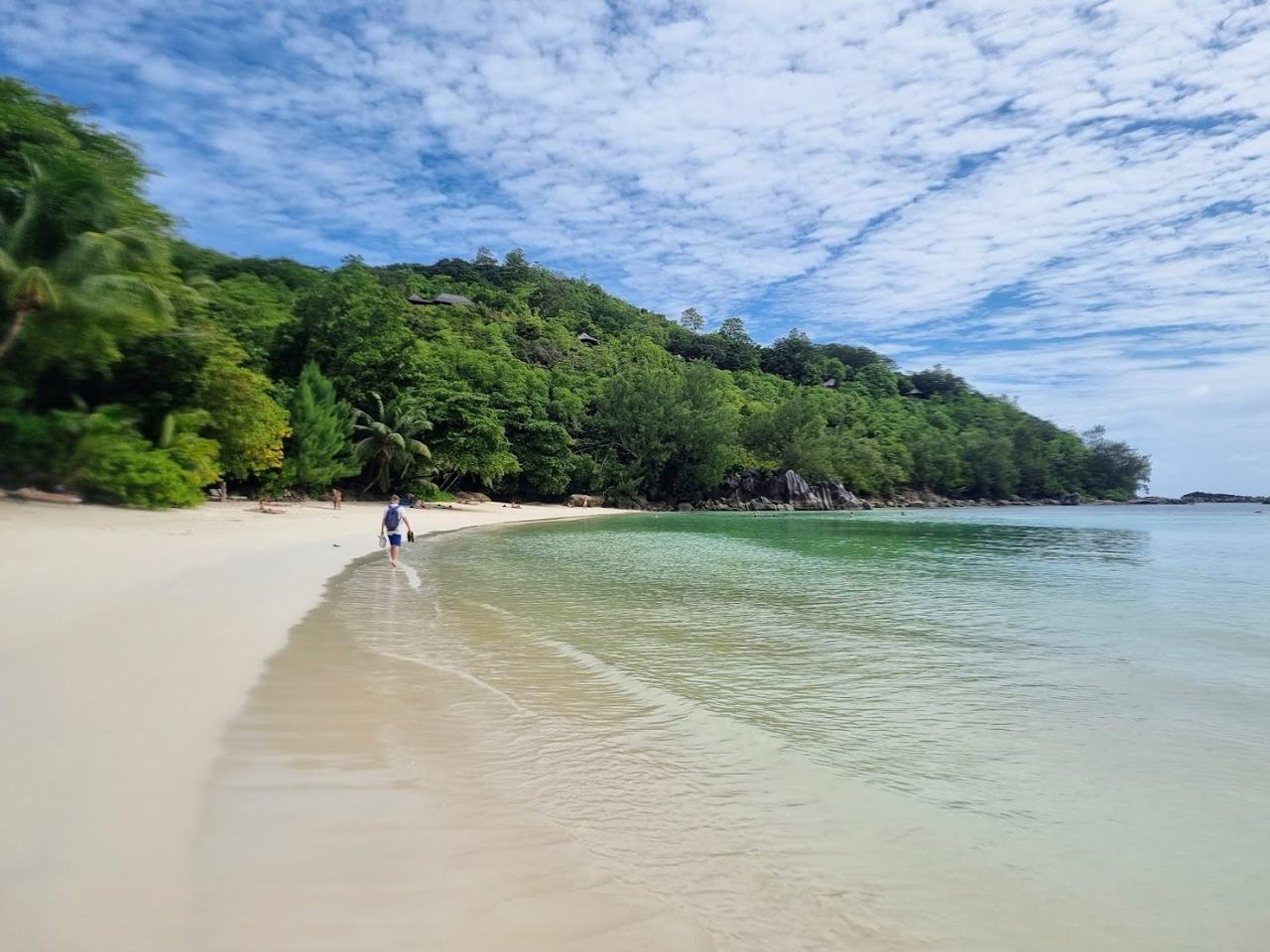 Clear calm bay and forested hills at Port Launay Marine National Park on north west Mahe