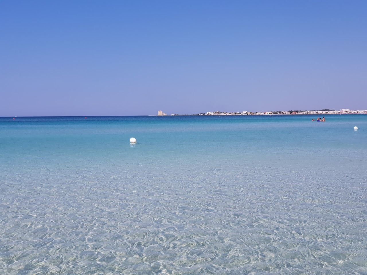 Long shallow turquoise water and white sand at Porto Cesareo in the Ionian marine reserve, Puglia