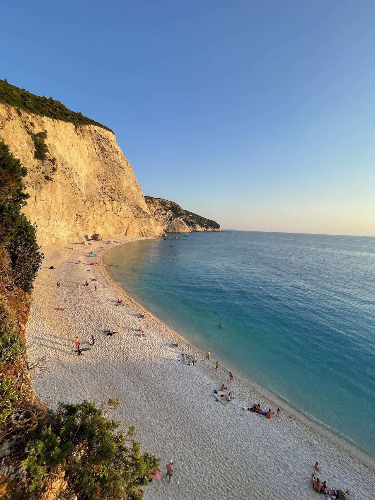 The towering white cliff and bright blue water seen from the staircase down to Porto Katsiki beach in Lefkada