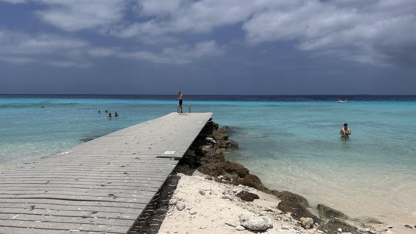 The white sand, twin piers and clear water of Playa Porto Mari on the west coast of Curacao