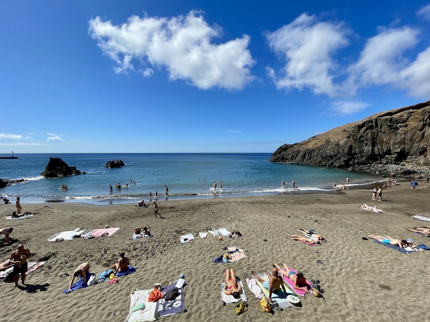Small coppery sand cove backed by arid ochre cliffs at Prainha near Canical on the eastern tip of Madeira