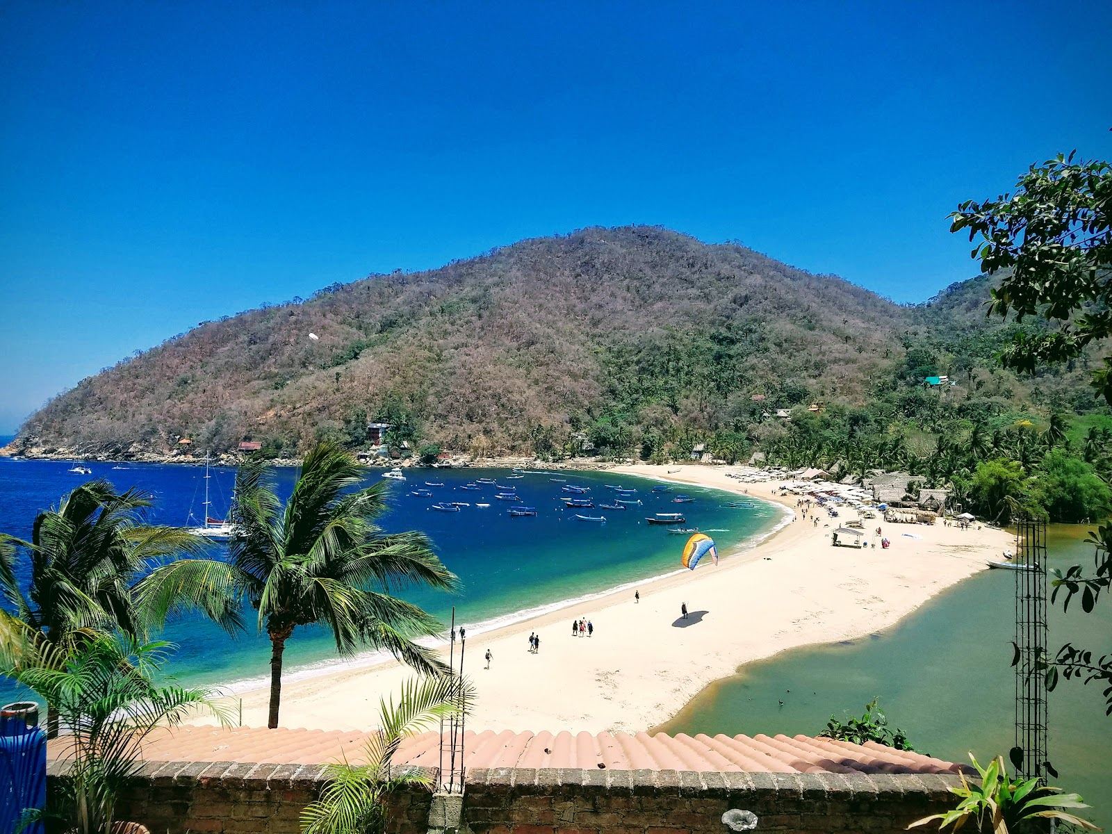 A calm palm backed cove on the car free south shore of Puerto Vallarta reached by boat
