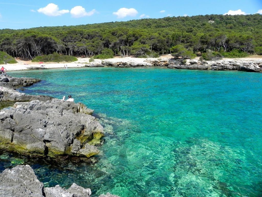 Clear blue water over rock at a snorkelling cove in Puglia