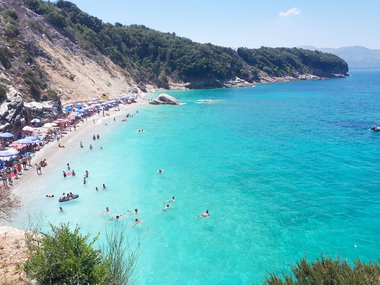 The rocky shoulders and clear water of the Pulebardha cove near Saranda on the Albanian Riviera