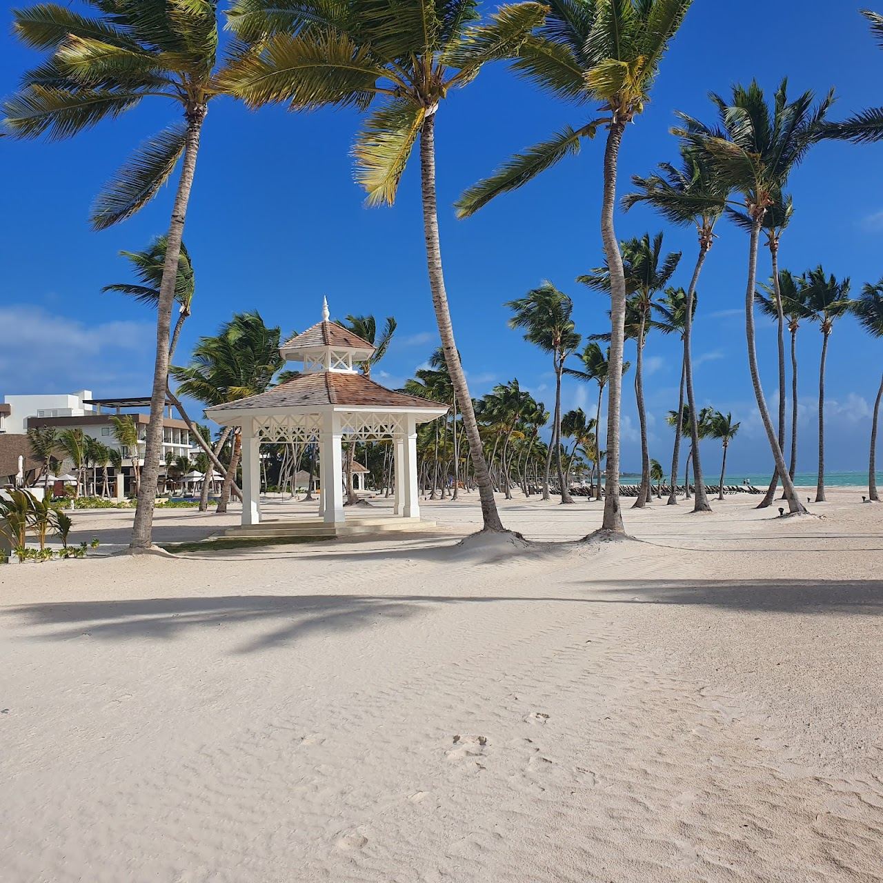 Calm turquoise water and pale sand in warm afternoon light at Juanillo Beach in Cap Cana, Punta Cana
