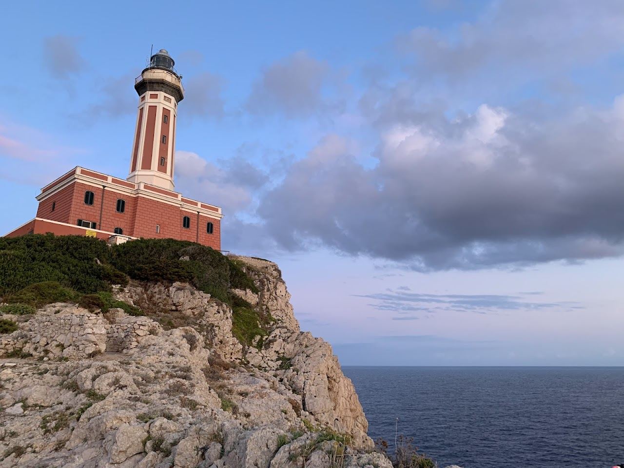 Flat rocks and swimming platforms below the Faro lighthouse at Punta Carena in Capri