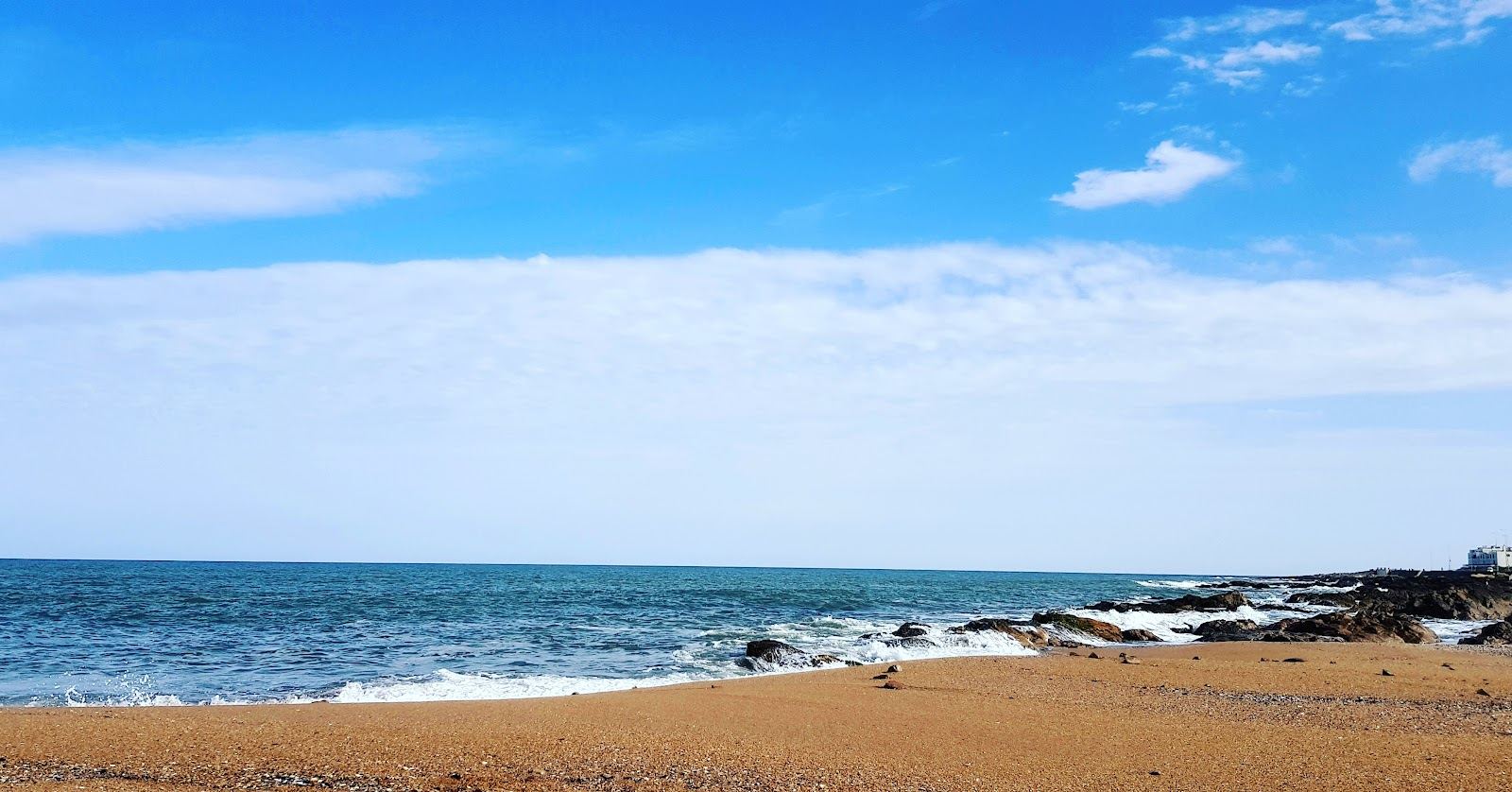 Golden hour light over the quiet shoreline at the tip of the Punta del Este peninsula