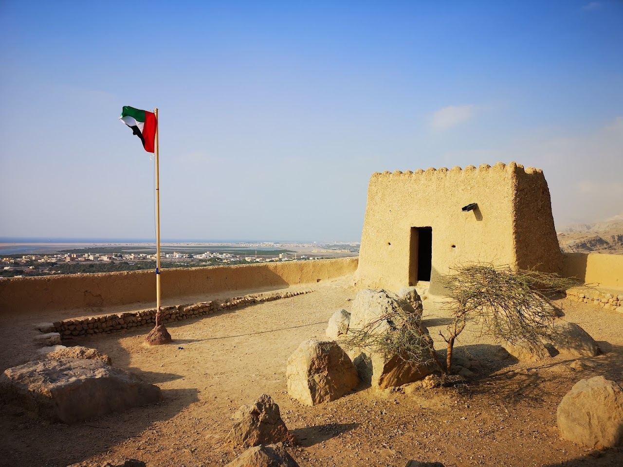 A quiet, undeveloped shore with calm water at the sunset hour in Ras Al Khaimah