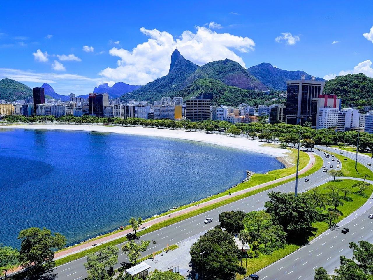 The long calm bay sand of Flamengo beach with Sugarloaf across the water in Rio de Janeiro