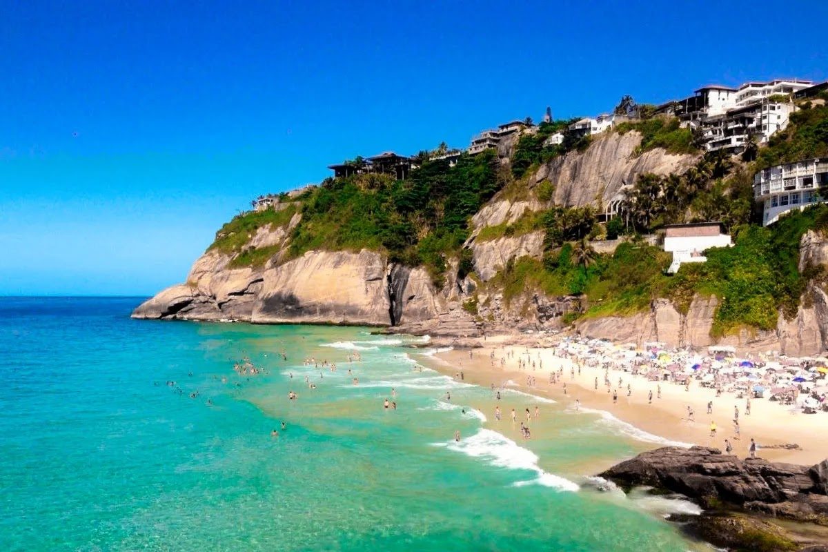 The hidden tidal cove of Joatinga beach below cliffs and smart homes in Rio de Janeiro